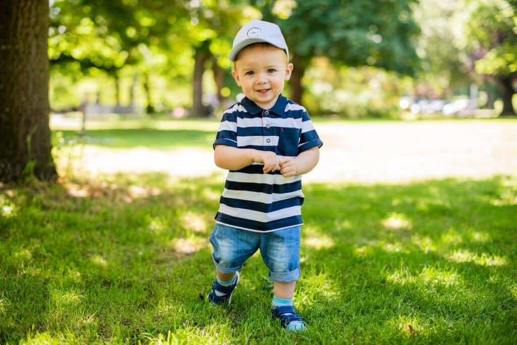 Baby Boy Walking On Grass